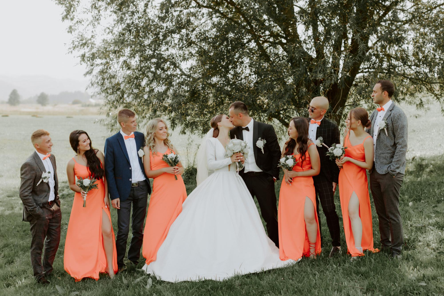 Wedding party with orange bridesmaid dresses