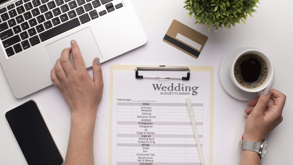 Wedding budget planner near a cup of coffee