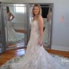 Girl standing in wedding dress in front of mirrors