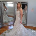 Girl standing in wedding dress in front of mirrors