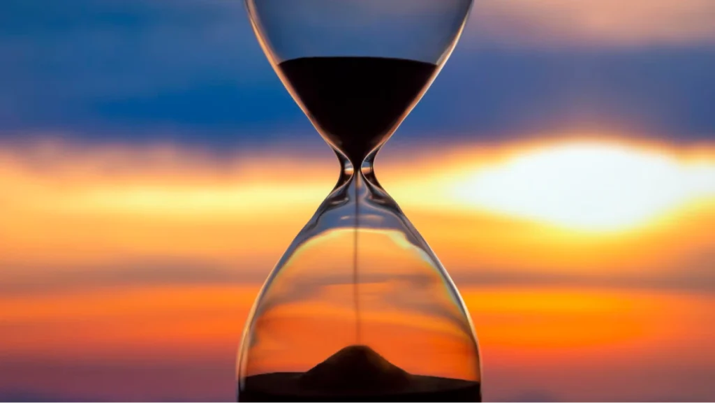 Hourglass with sunset in the background