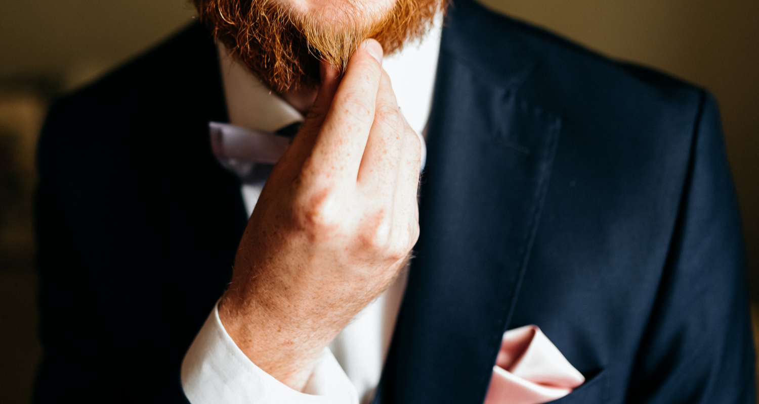 Man touching his ginger beard