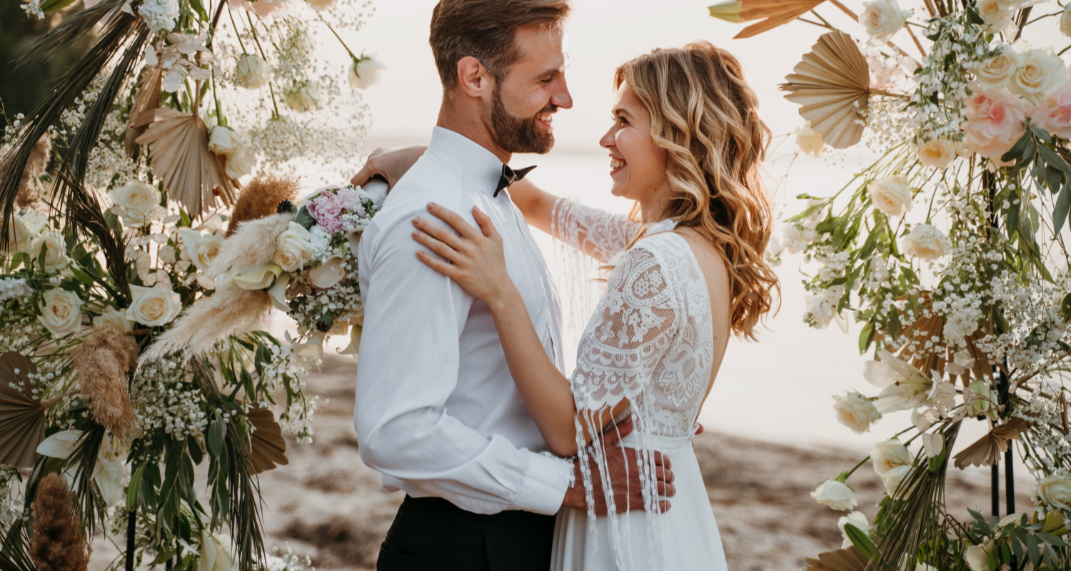 Bride and groom smiling romantically.