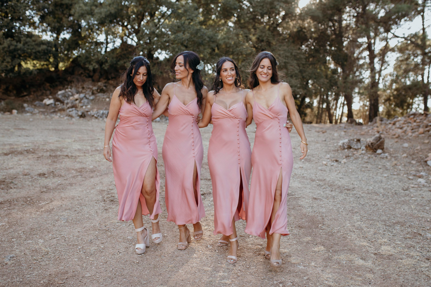 Bridesmaids walking in matching dresses.